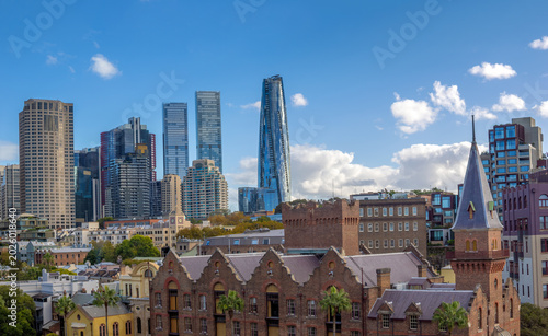 Photos Historical buildings of  the Rocks precinct on the southern shore of Sydney Harbour with the skyline of Sydney CBD