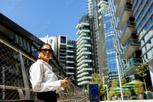 Woman stands in modern city...