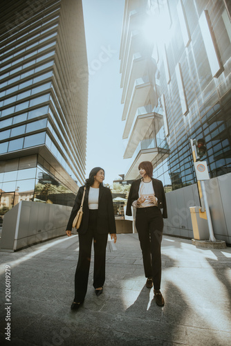 Two women walking in busine...