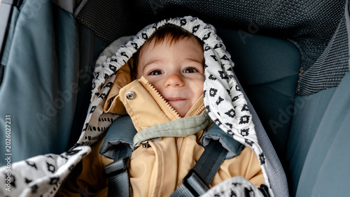 Cozy baby in stroller during outdoor stroll in warm blanket