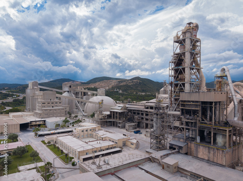 Photos Elevated view of a large cement manufacturing facility featuring a multi-stage c
