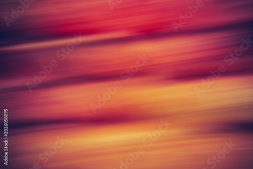 Abstract motion blur background with warm gradient streaks