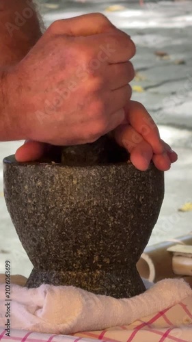 Closeup of Hands with a Mortar and Pestle 