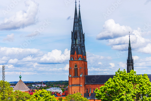 Beautiful view of cathedral towers above city landscape on cloudy sky background. Sweden. Uppsala. 