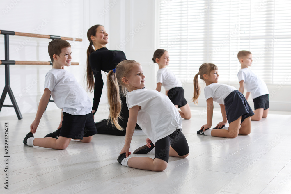 Fototapeta premium Professional dance teacher training children in studio, selective focus