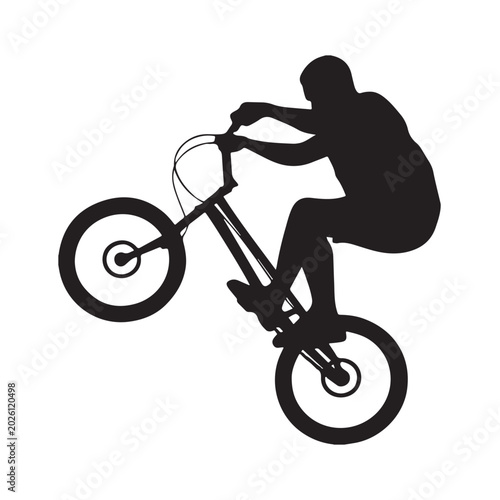 Tableau sur toile Silhouette of a mountain bike rider performing a wheelie stunt.