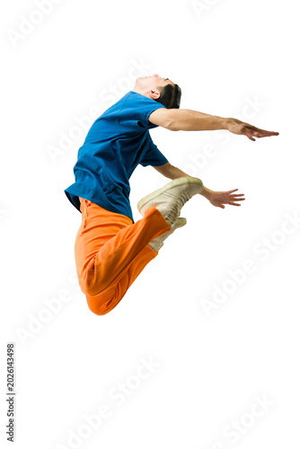 Dynamic young male dancer performing an athletic jump, wearing colorful urban streetwear, flying effortlessly mid-air on white