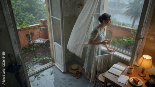 Young Woman Watching the Summer Rain From Her Balcony