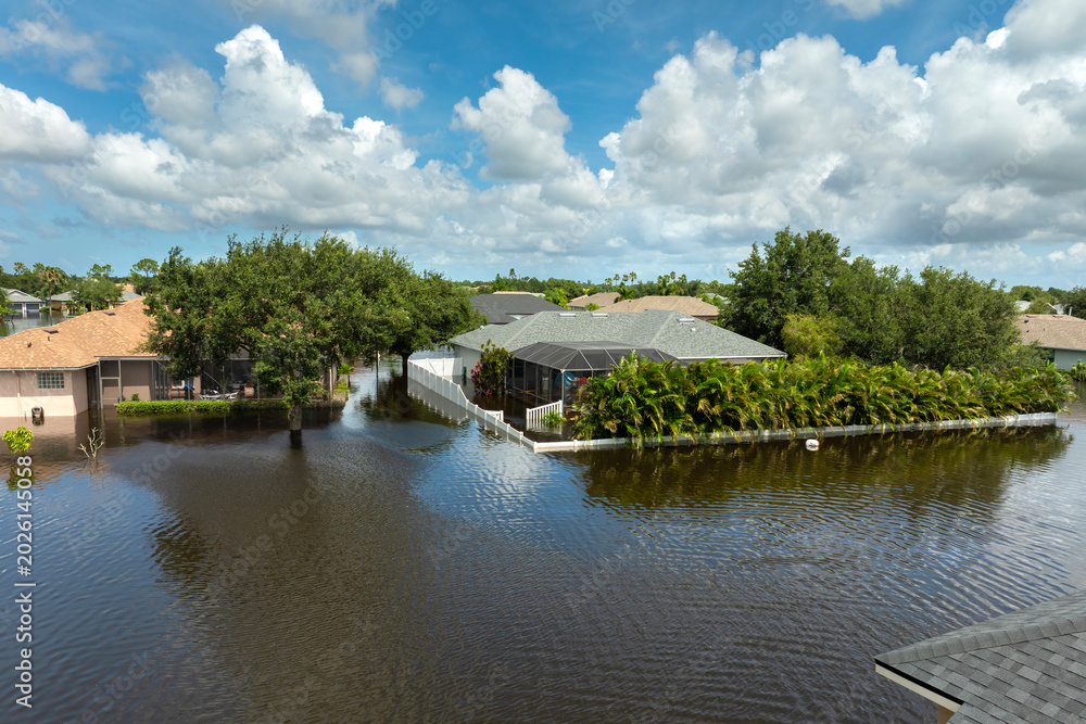 Fototapeta premium Tropical rainstorm flooded residential homes in suburban community in Florida. Hurricane aftermath