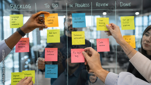 Business team organizing tasks with sticky notes on Kanban board