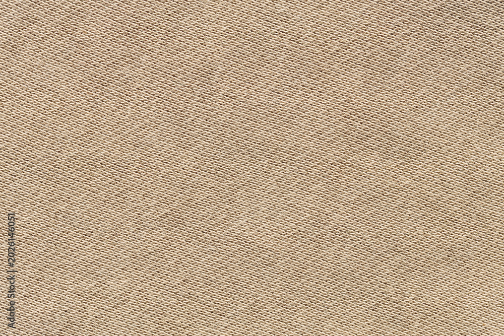 Fototapeta premium Beige woven canvas fabric texture background with diagonal pattern close-up