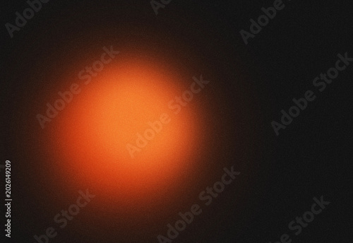 Abstract dark background with warm orange glowing light circle and subtle starry texture