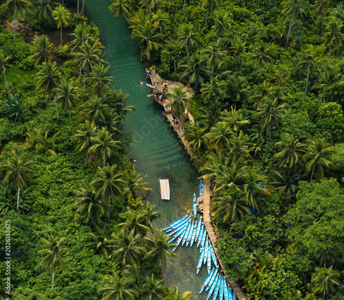 Maasin River is a lush, emerald-green waterway in Pilar, Siargao, Philippines, celebrated for its tranquil mangrove surroundings and towering palm trees