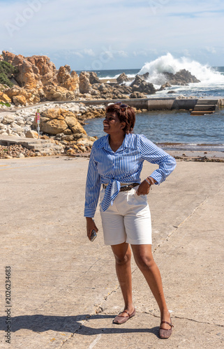 Kleinmond Western Cape South Africa. 05.11.2026.  Attractive female holidamaker exercising on the seafront at Kleinmond in the Western cape South Africa.