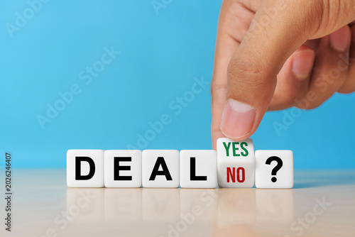 Deal or no deal? Hand turns a cube and changes the word 