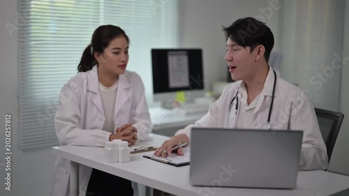 Medical Consultation Between Female and Male Doctors in Hospital Office