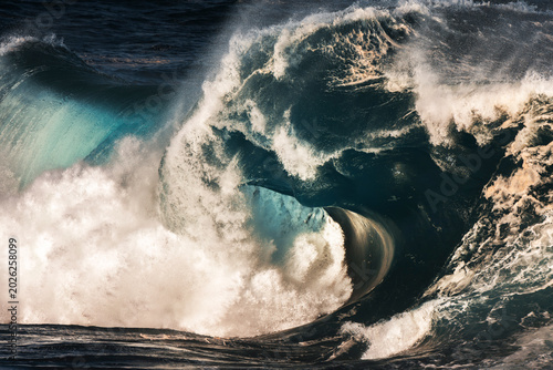 Giant storm wave breaking along the Sydney east coast, Australia with powerful surf, sea spray and dramatic ocean energy.