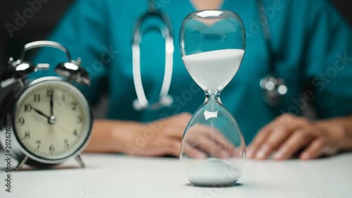 Doctor with hourglass and clock.