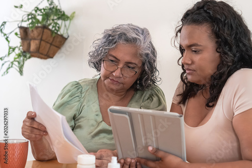 Adult daughter assisting senior mother with long-term care finances
