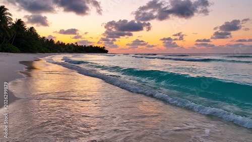 Tropical beach sunset with gentle waves washing onto white sand