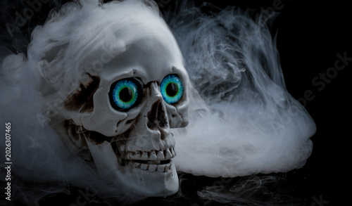 Bild auf Leinwand Plastic home made Skull with strange glowing eyes with spooky strange swirling s