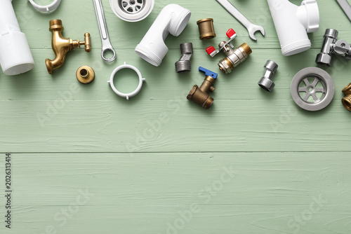 Set of plumber's items on g...