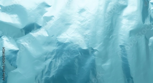 Crinkled metallic surface with cool blue and white tones