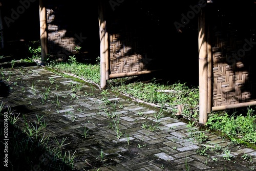 Partition wall made of woven bark with cylindrical bamboo as the main structure