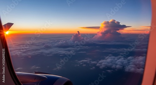 Sunrise glow over clouds from airplane window