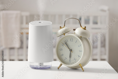 Canvastavla Modern humidifier and alarm clock on bedside table in children's bedroom