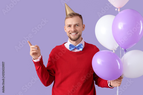Happy young man with balloo...