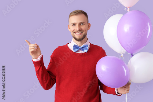 Happy young man with balloo...