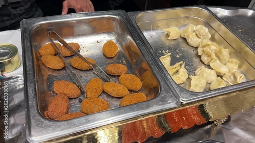 A premium appetizer presentation featuring traditional crispy Bengali vegetable chops alongside modern melted cheese momos at a luxury wedding reception in West Bengal, India.