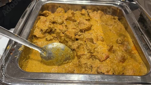 A rich and aromatic Katla fish curry (Katla Kalia) elegantly served in traditional tableware at a grand festive banquet in West Bengal, India.