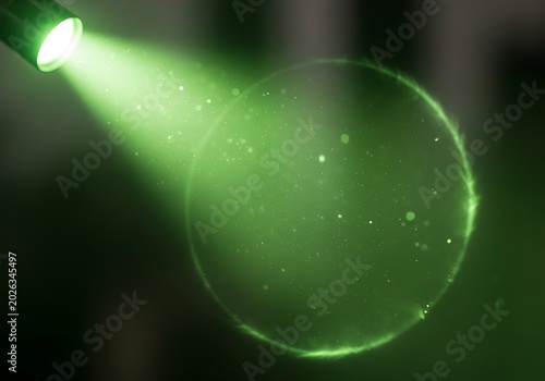 Bright Green Spotlight Beam Illuminating Floating Particles in Dark Abstract Scene