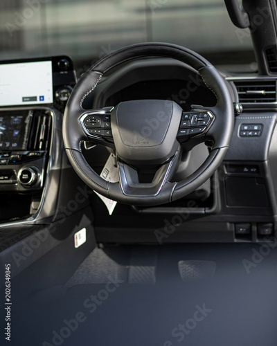 Interior View of Modern Car Steering Wheel and Dashboard.
