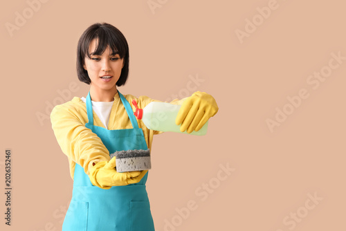 Young woman with sponge and...