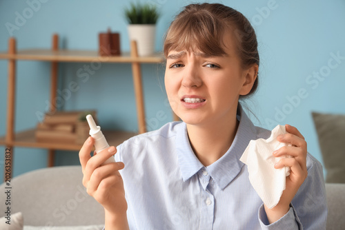 Ill young woman with nasal ...