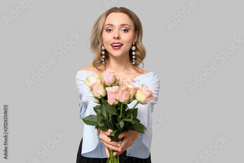 Young woman with bouquet of...