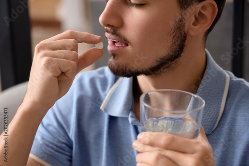 Young man with glass of wat...