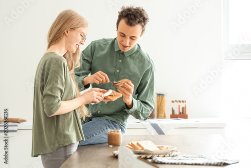 Young woman and man spreadi...