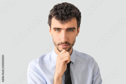 Thoughtful young businessma...