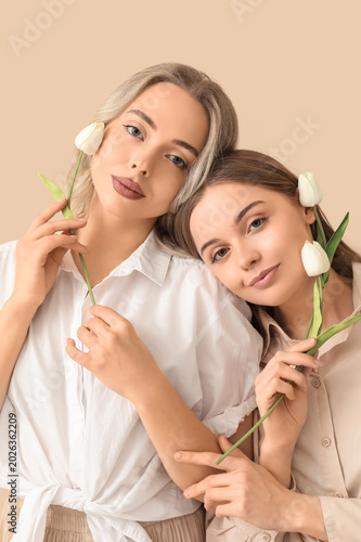 Young sisters with tulips o...