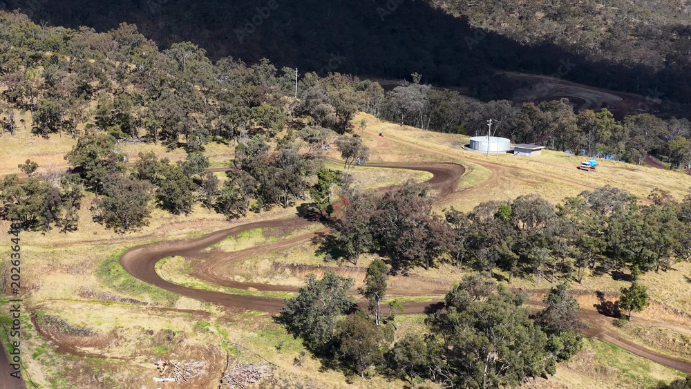Obraz premium Aerial View of Winding Dirt Track in Australian Bushland