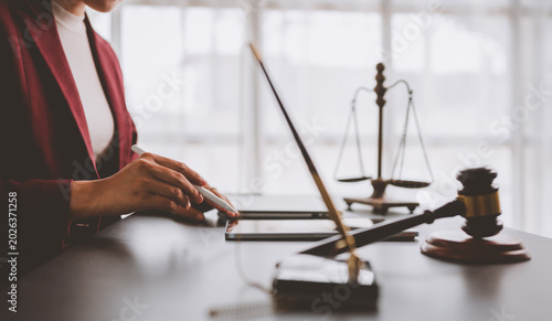 Businesswoman working on tablet with legal symbols
