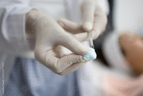Foto Gentle hands perform precise facial treatment with tools