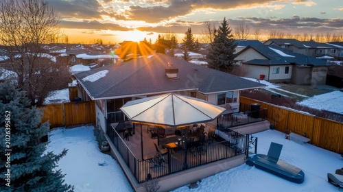 Winter Sunset Over Suburban Home with Deck and Patio Umbrella