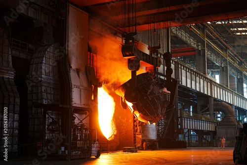 Bild auf Leinwand At the blast furnace site of the steel plant, a heavy steel structure factory bu