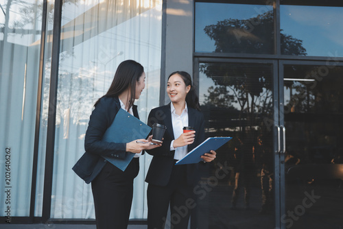 Business people walking and talk to each other in front of modern office