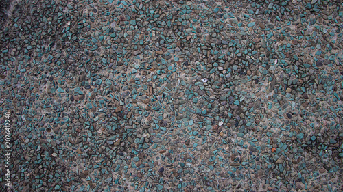Obraz na płótnie Top view of pebble wash texture with turquoise and grey stones background